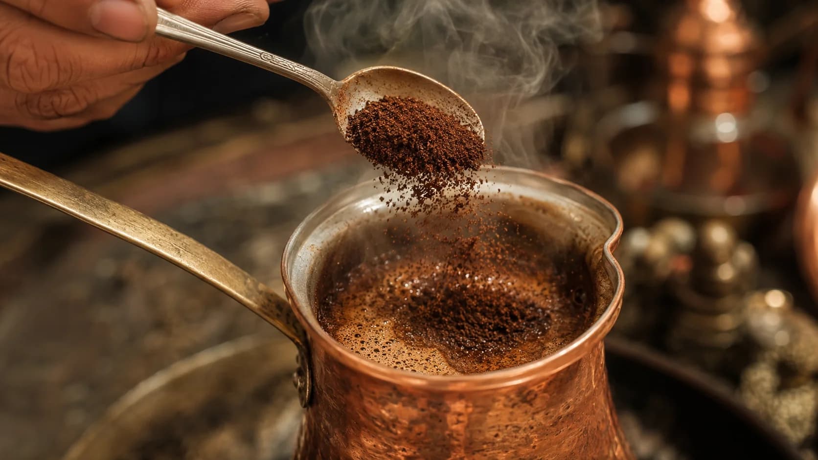 Fine coffee grounds being added to a steaming copper dzezva for Bosnian coffee