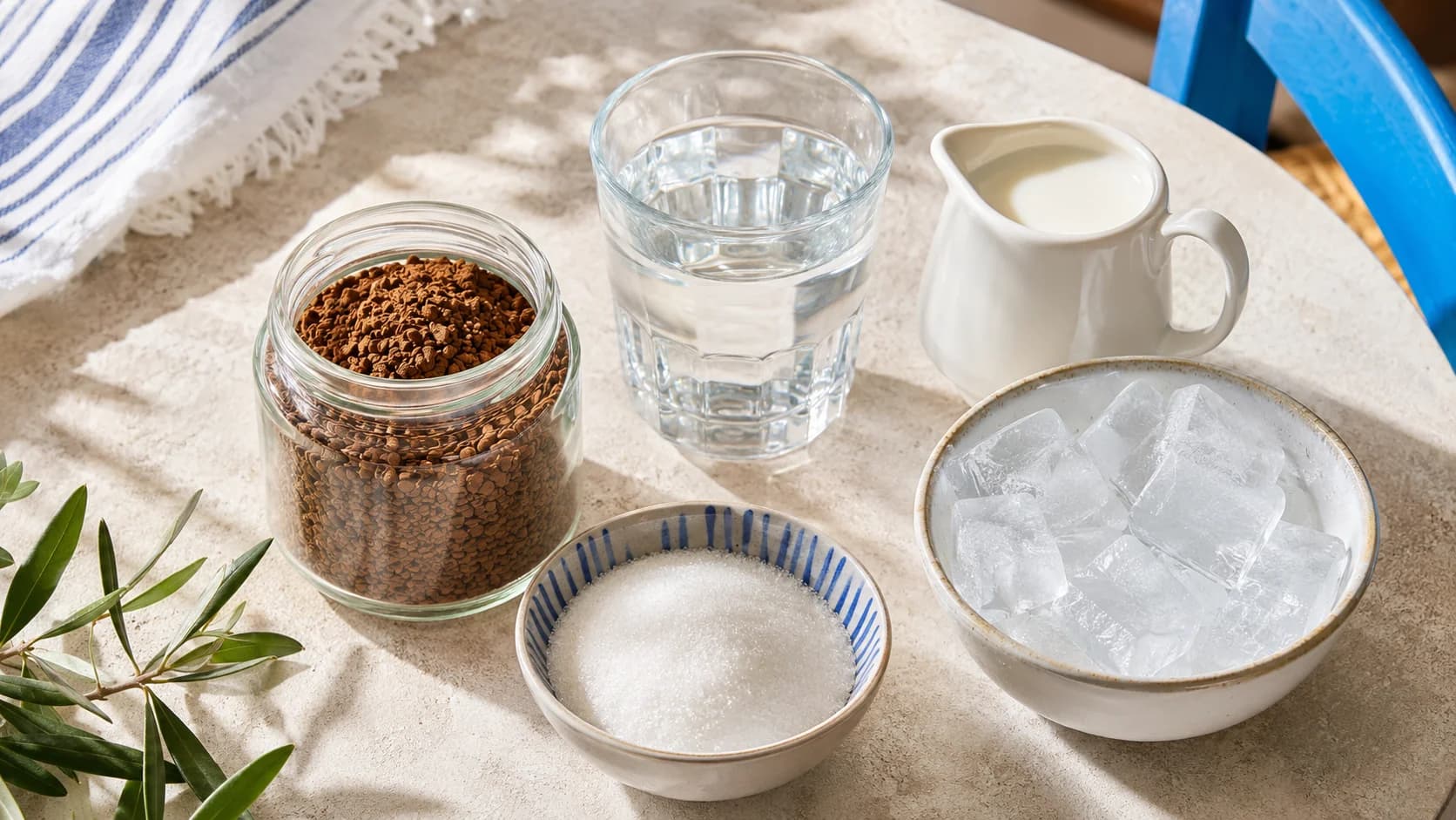 Instant coffee, sugar, cold water and ice measured for Greek frappé