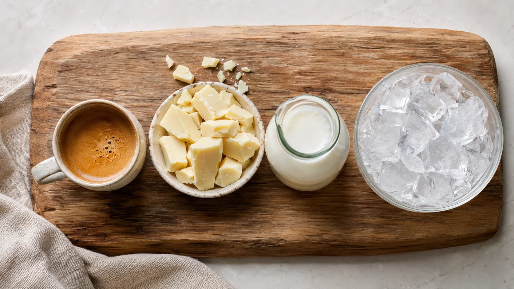 White chocolate, espresso, cold milk and ice ingredients for an iced white mocha