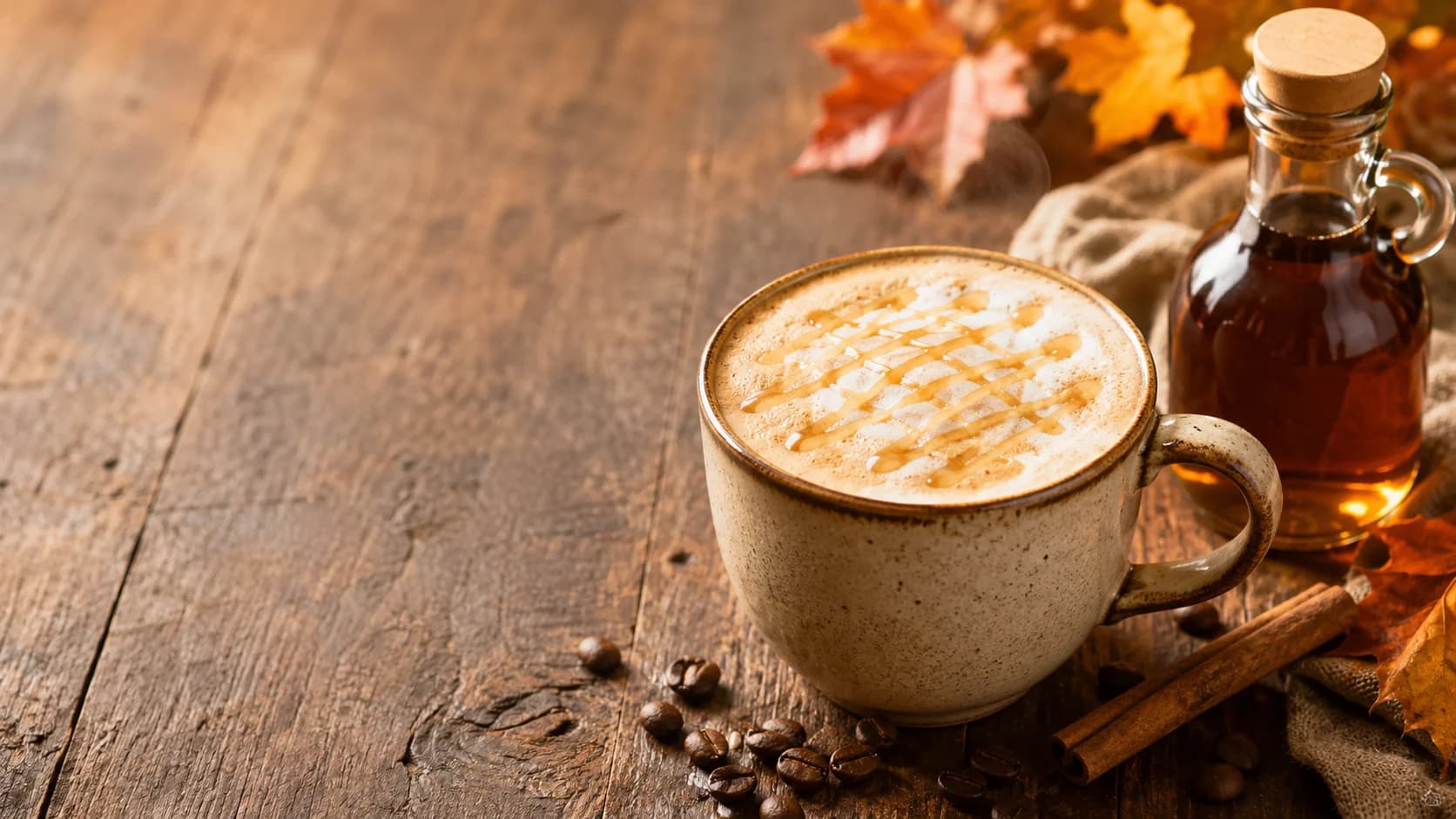 Maple latte with steamed milk and pure maple syrup beside the ceramic cup