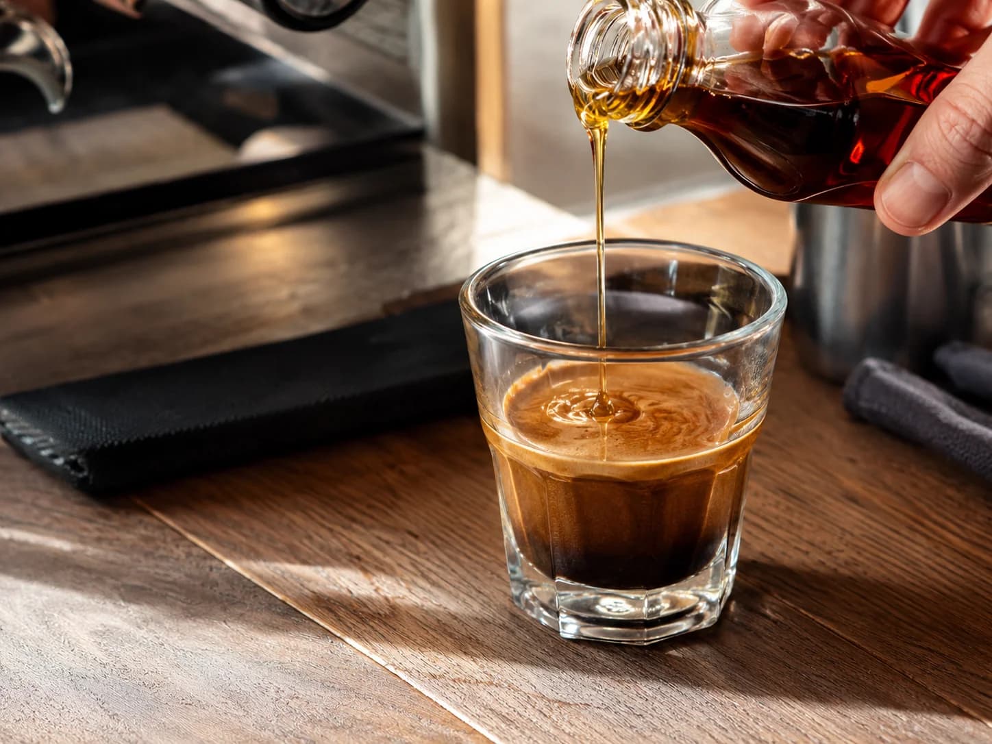 Pure maple syrup being mixed with espresso before steamed milk is added
