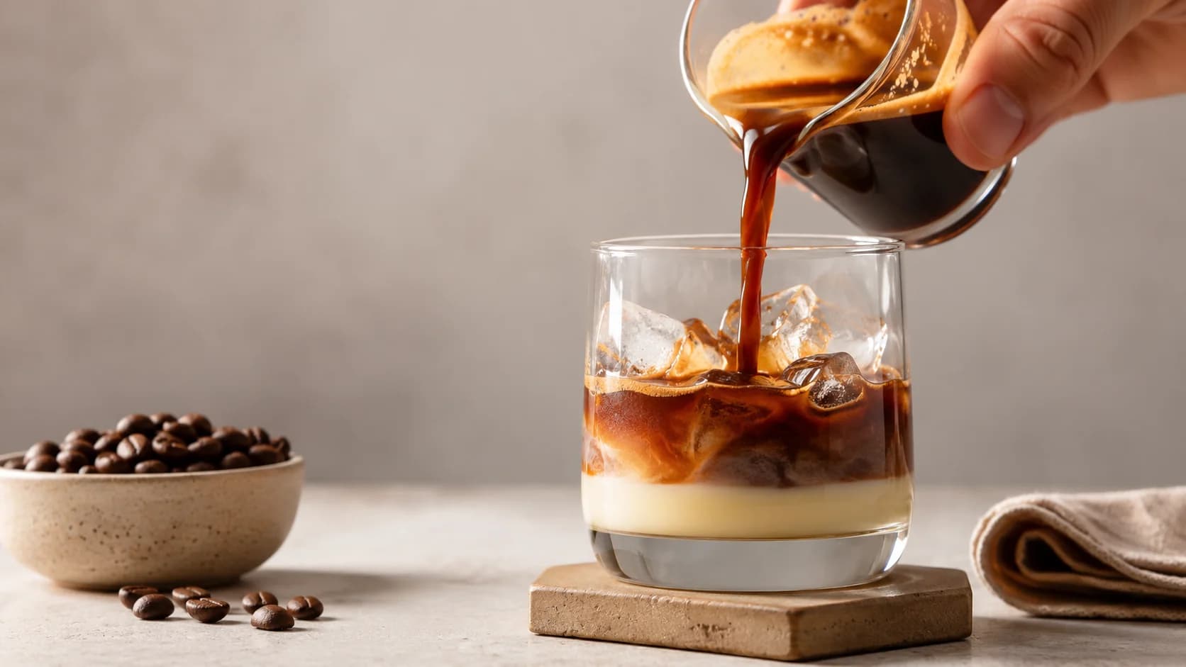Sweetened condensed milk being combined with espresso for a Spanish latte
